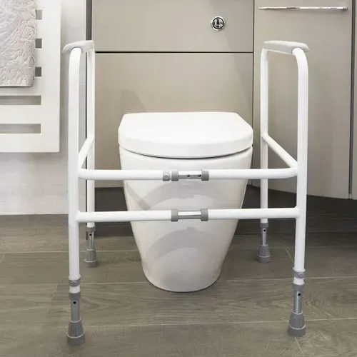 Width-adjustable toilet surround frame positioned around a toilet in a bathroom